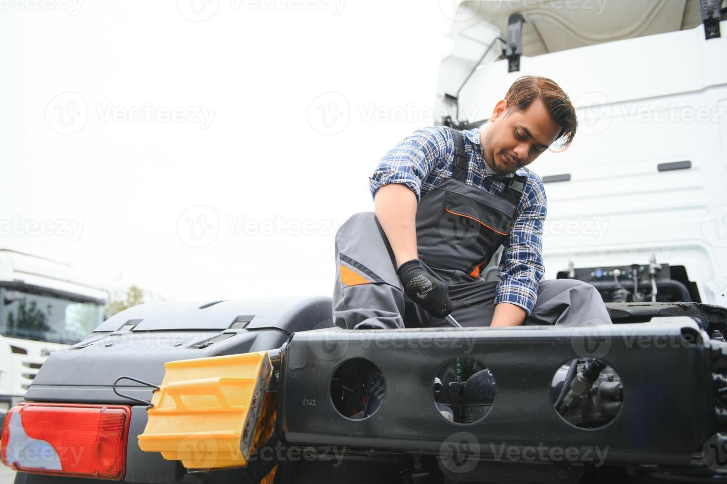 Man in uniform. Truck repair. Car malfunction. photo