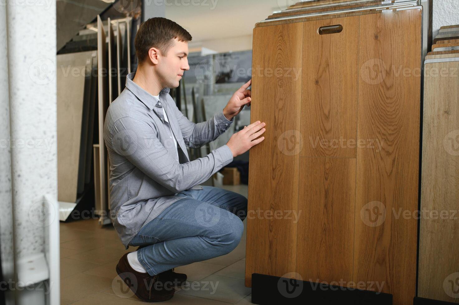 Choosing parquet. Man is in the store of goods for the home photo