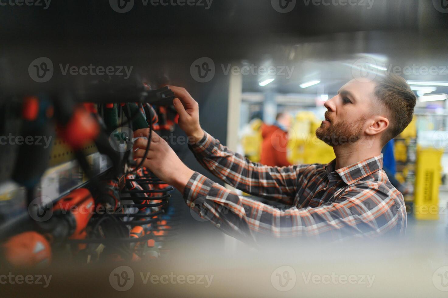 Portrait of happy mature man standing in hardware store photo