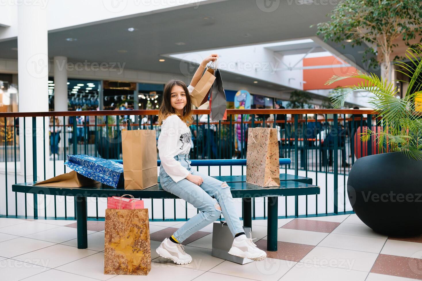 shopping, happiness and people concept - smiling stylish teenage girl with shopping bags. shopping concept. photo