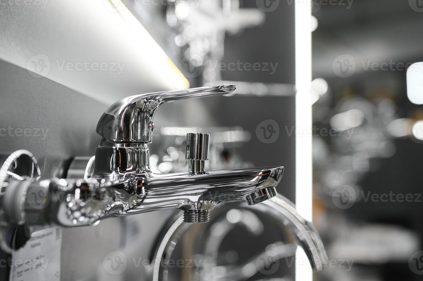 Water taps of different types and shapes on the counter in the store. Retail trade in sanitary ware. Foreground. photo