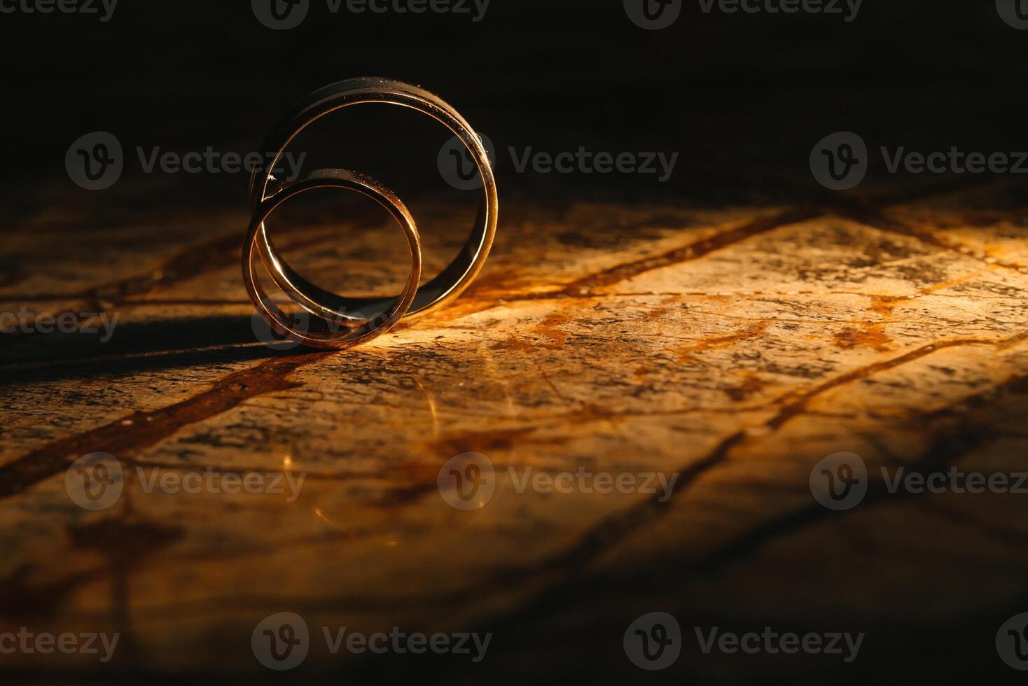 Couple wedding rings on old marble texture. photo