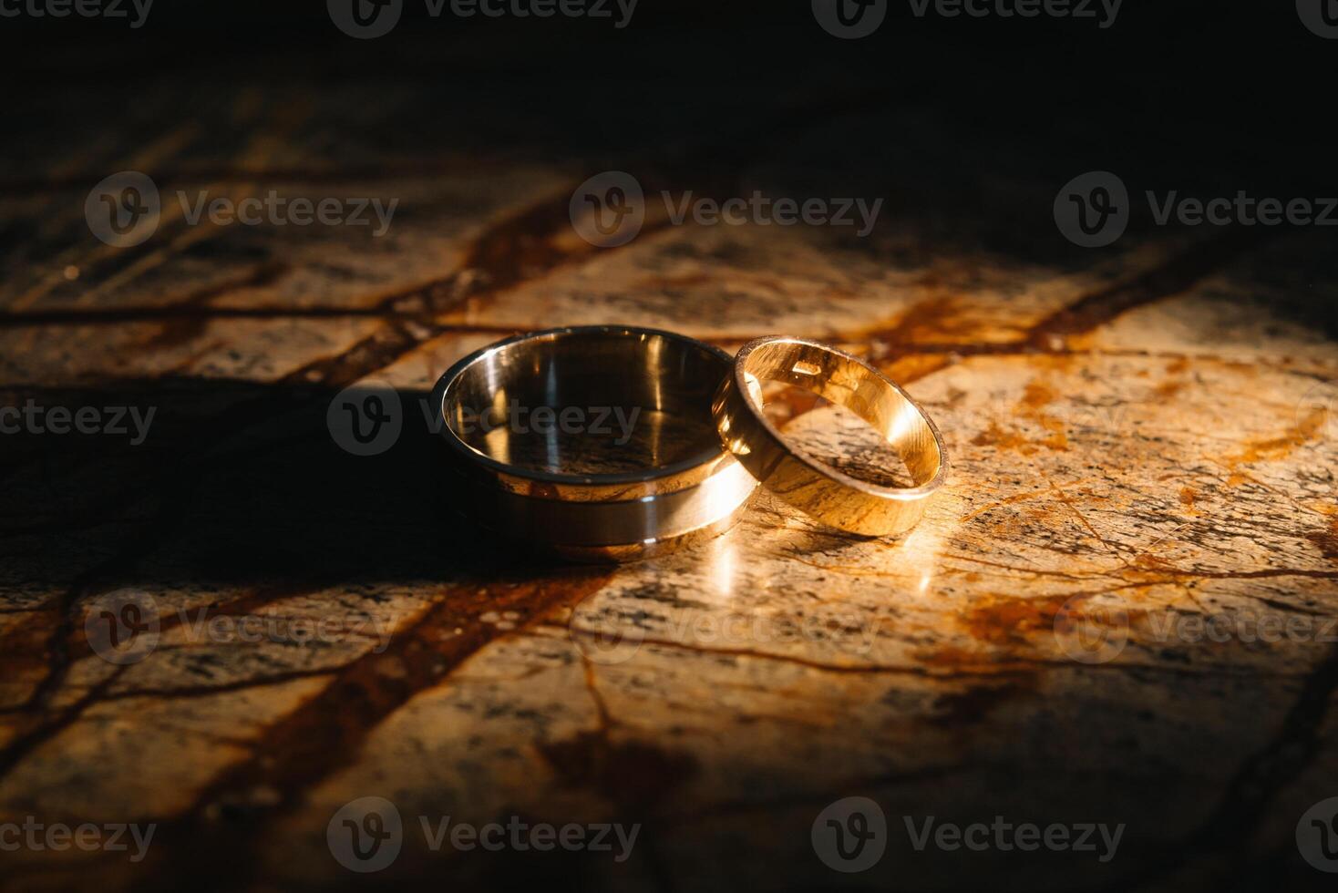 Couple wedding rings on old marble texture. photo