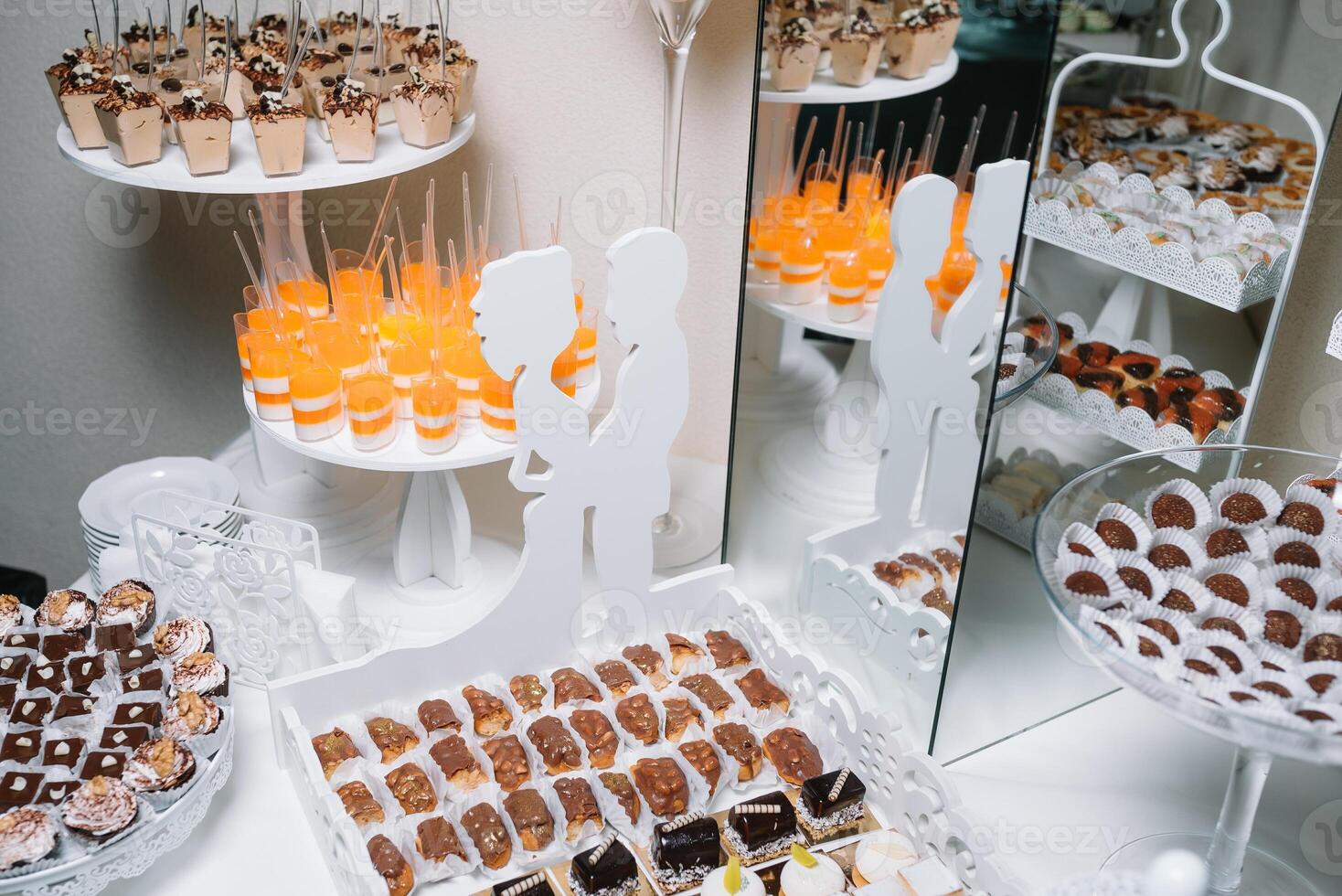 Different fruit desserts with fruits in glasses on the table. Restaurant presentation, food, party concept photo