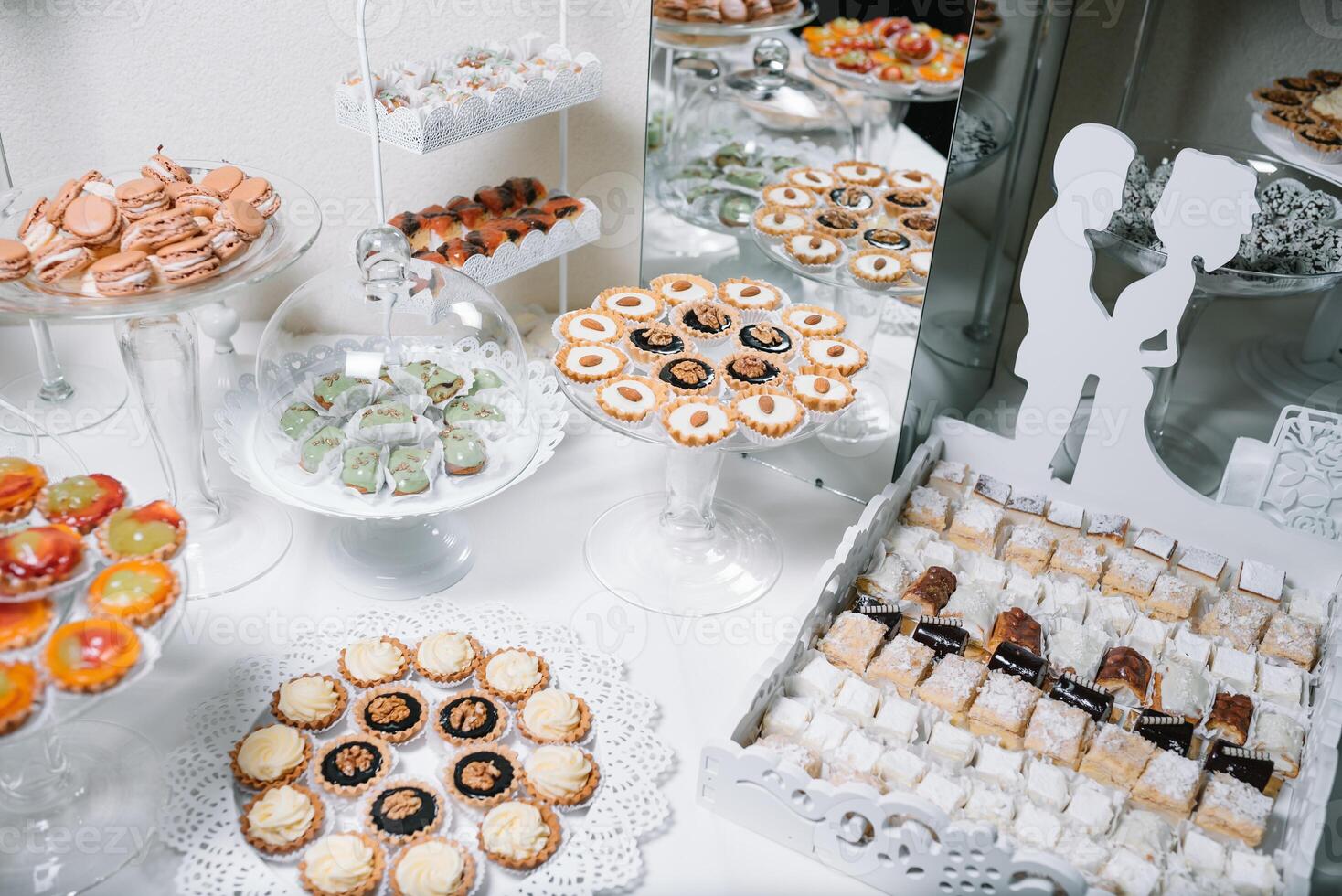 Different fruit desserts with fruits in glasses on the table. Restaurant presentation, food, party concept photo