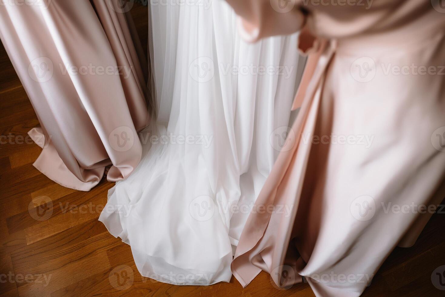 Bridesmaid preparing bride for wedding day. Bridesmaid helping bride fasten lacing her wedding white dress before ceremony. Luxury bridal dress close up. Wedding morning moments details concept. photo