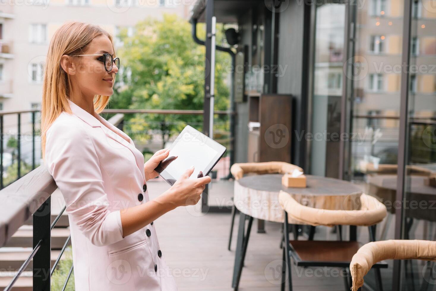 Portrait of young attractive businesswoman examining paperwork in bight light office interior sitting next to the window, business woman read some documents before meeting, filtered image. photo