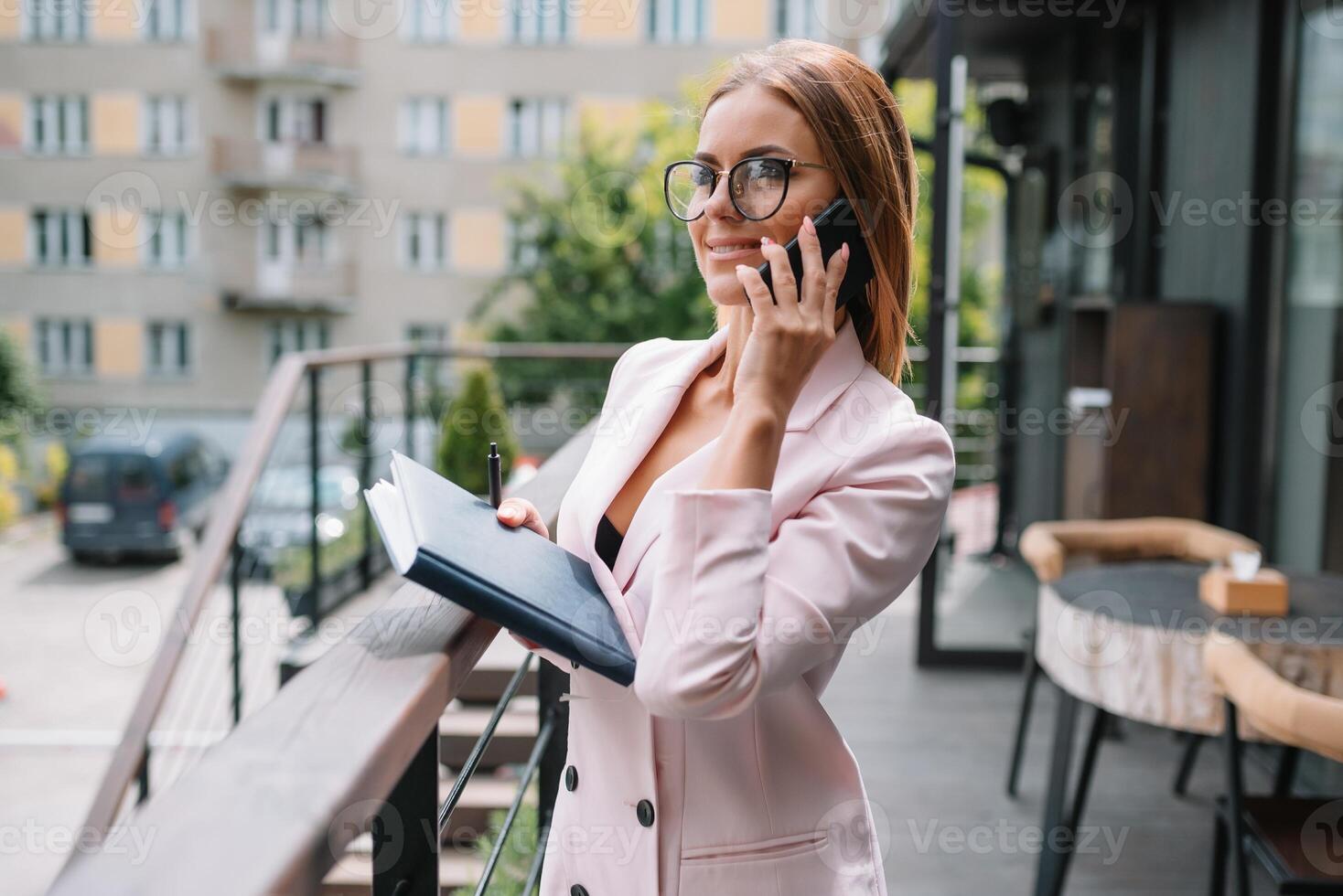 Portrait of young attractive businesswoman examining paperwork in bight light office interior sitting next to the window, business woman read some documents before meeting, filtered image. photo