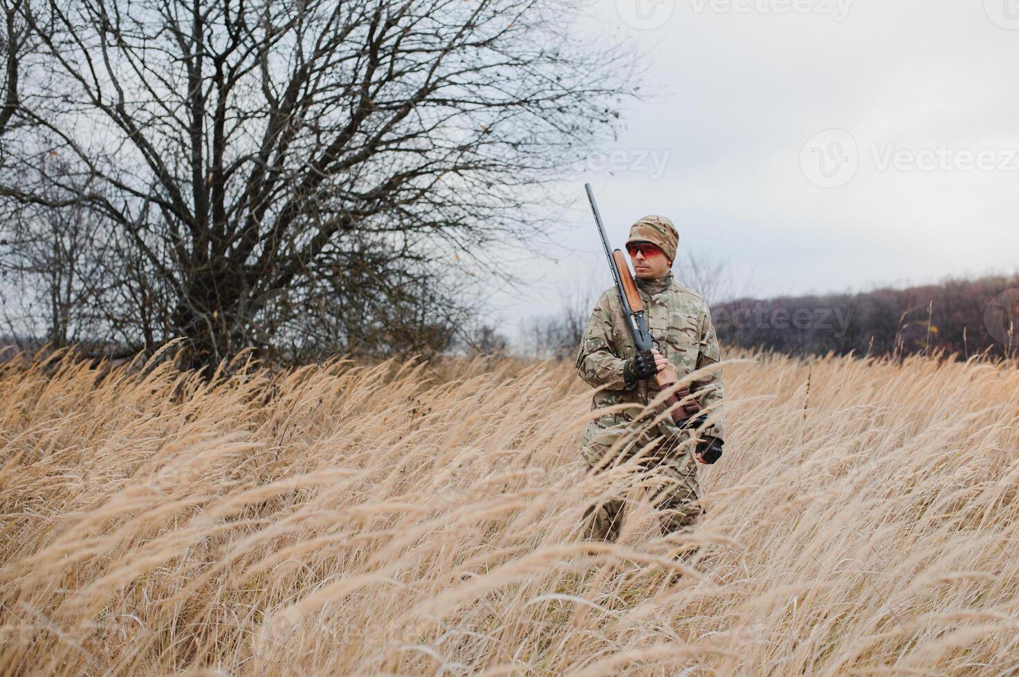 The hunter takes aim at the wild beast in the forest. Hunting concept photo