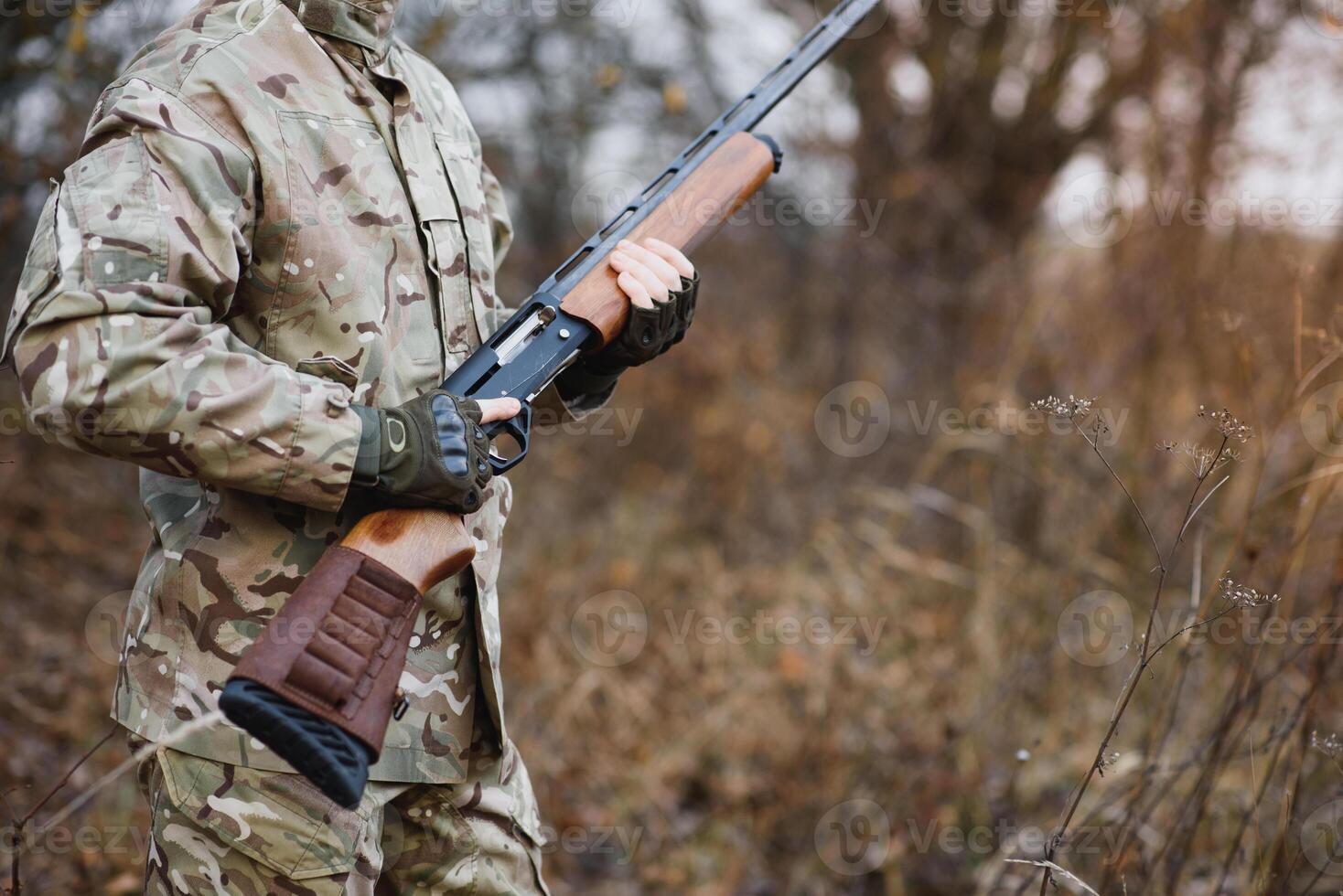 Hunter handsome guy with weapon. Hunter spend leisure hunting. Hunting equipment. Brutal masculine hobby. Man observing nature background. Hunter hold rifle. Safety measures. Natural environment photo