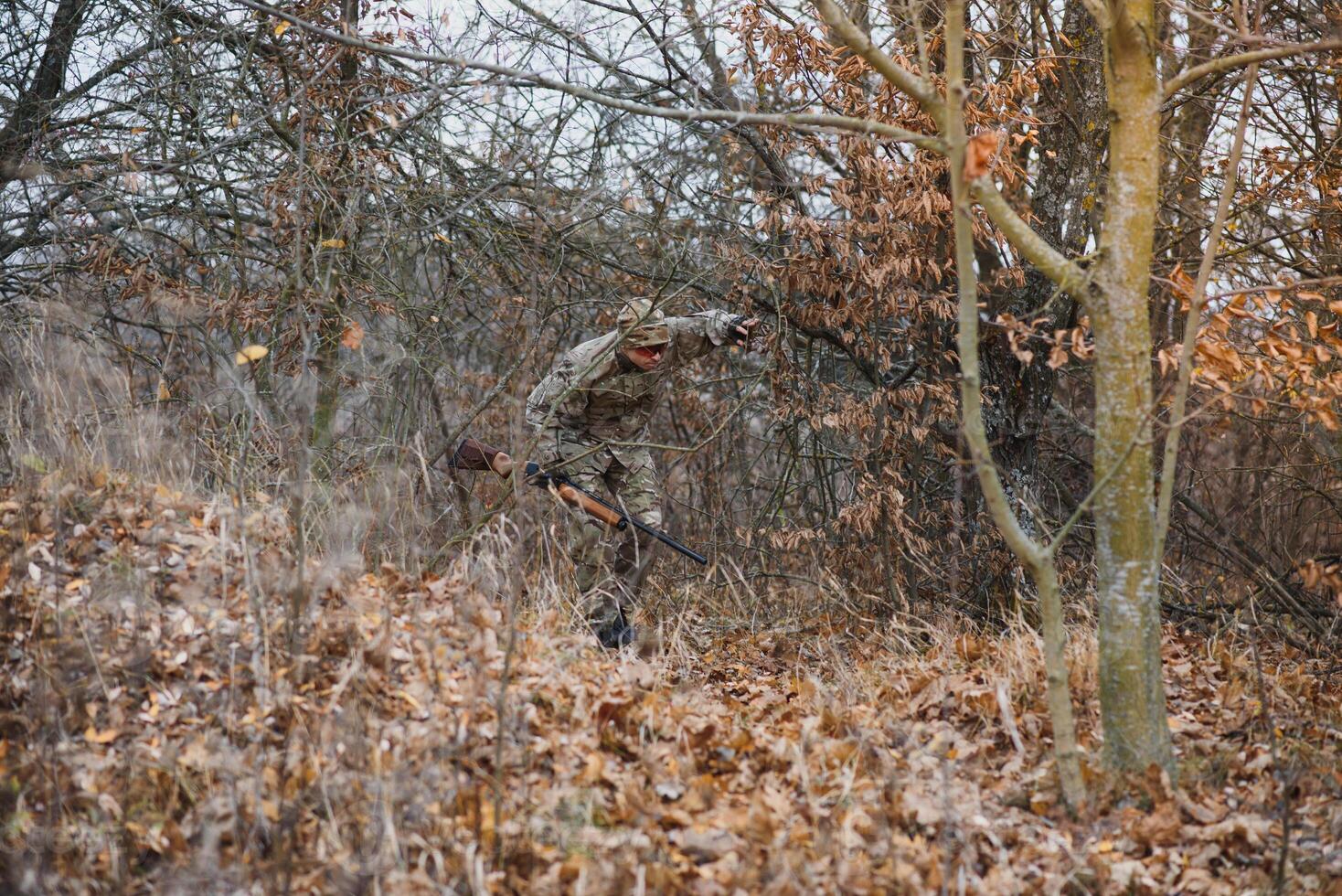 Hunter in uniform with a hunting rifle. Hunting Concept. photo