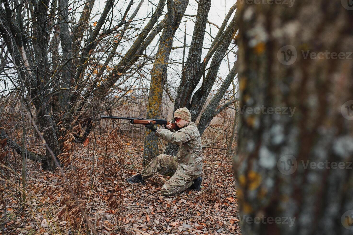 Hunter in uniform with a hunting rifle. Hunting Concept. photo