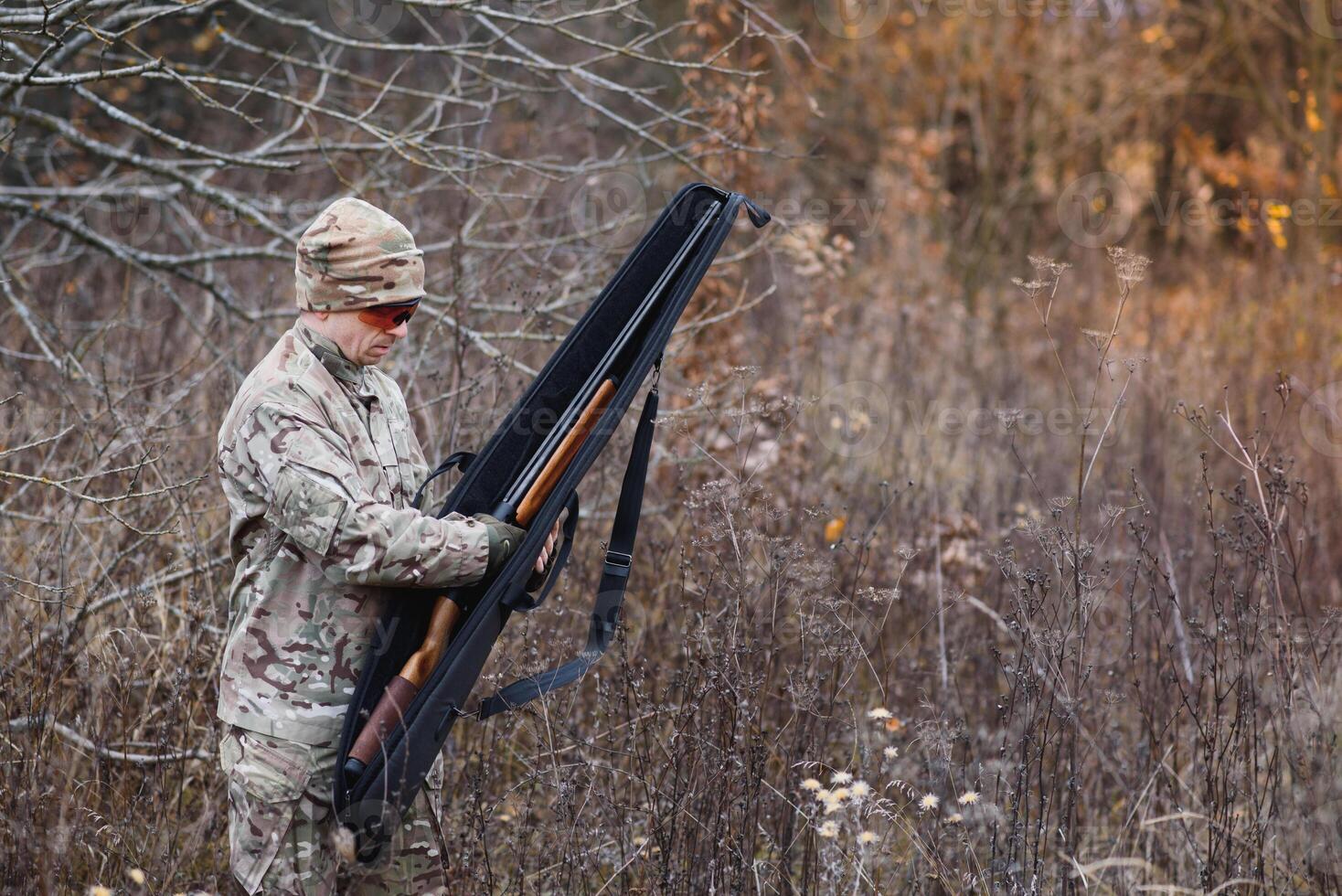 Hunter in uniform with a hunting rifle. Hunting Concept. photo
