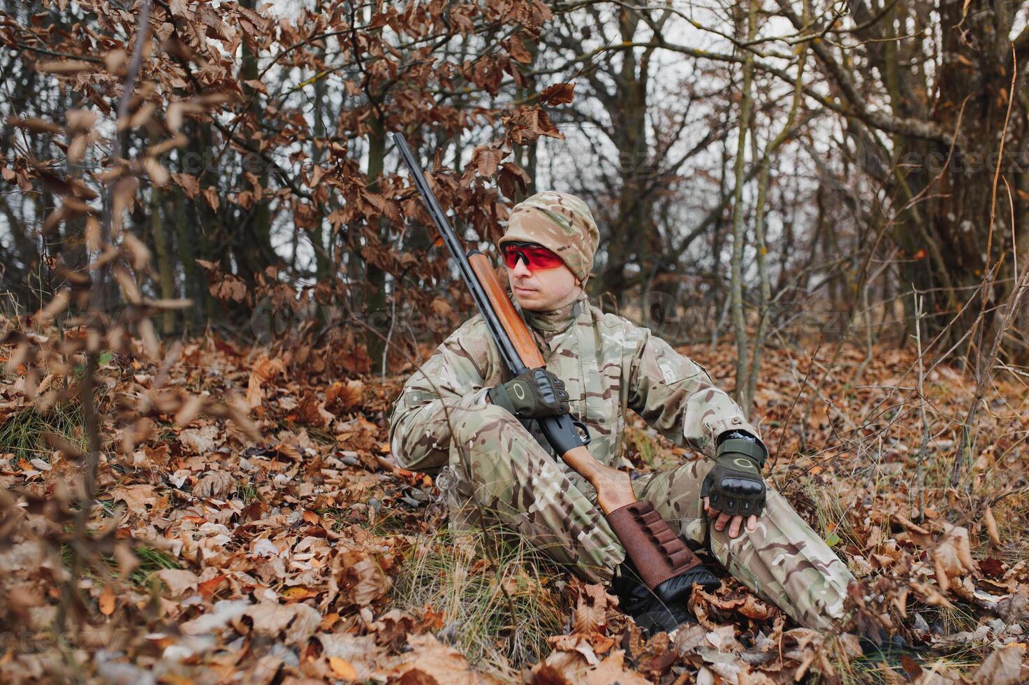 The hunter takes aim at the wild beast in the forest. Hunting concept. photo