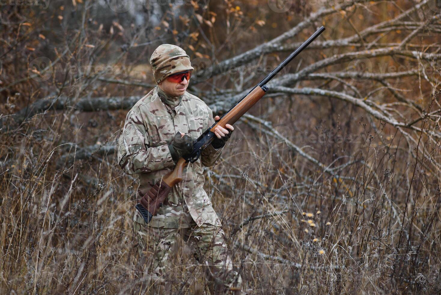 Hunter in uniform with a hunting rifle. Hunting Concept. photo