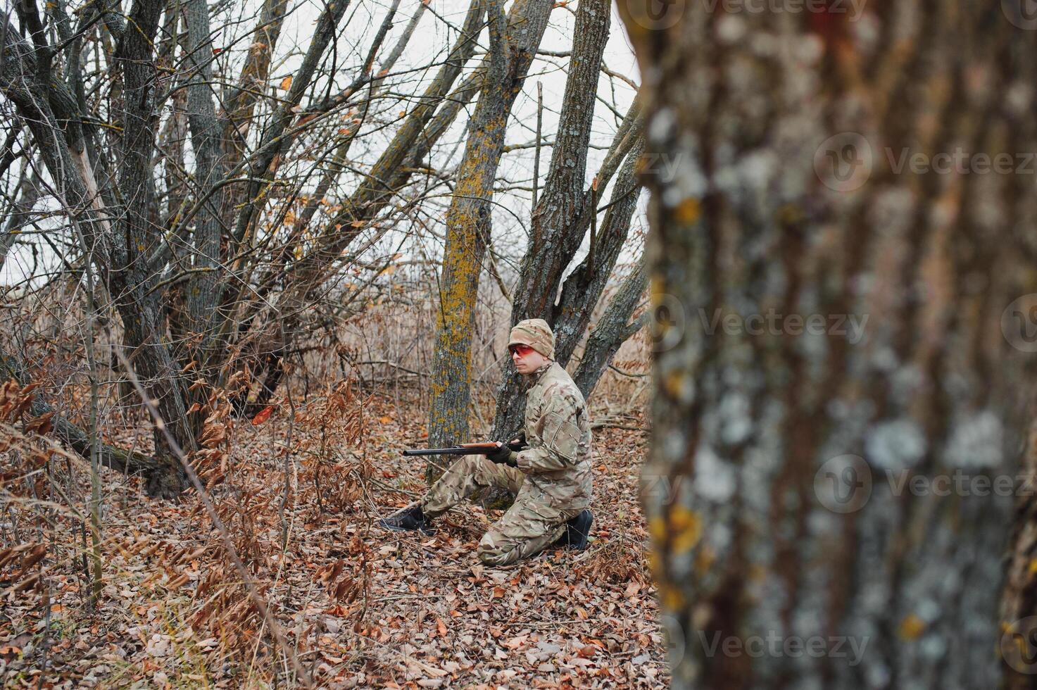 Hunter in uniform with a hunting rifle. Hunting Concept. photo
