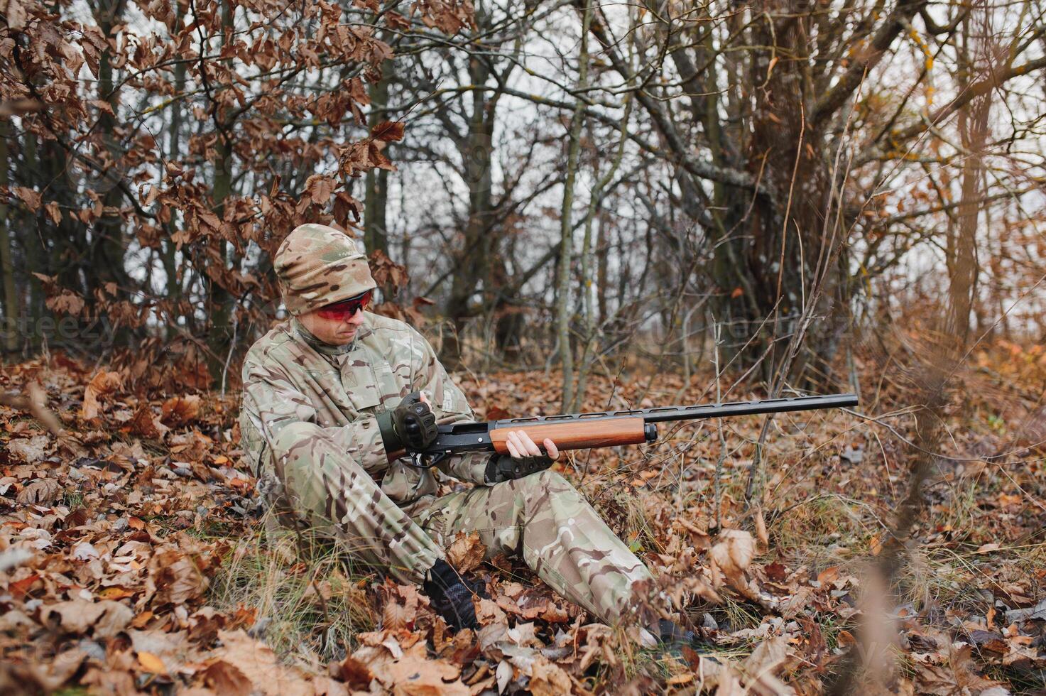Hunter in uniform with a hunting rifle. Hunting Concept. photo