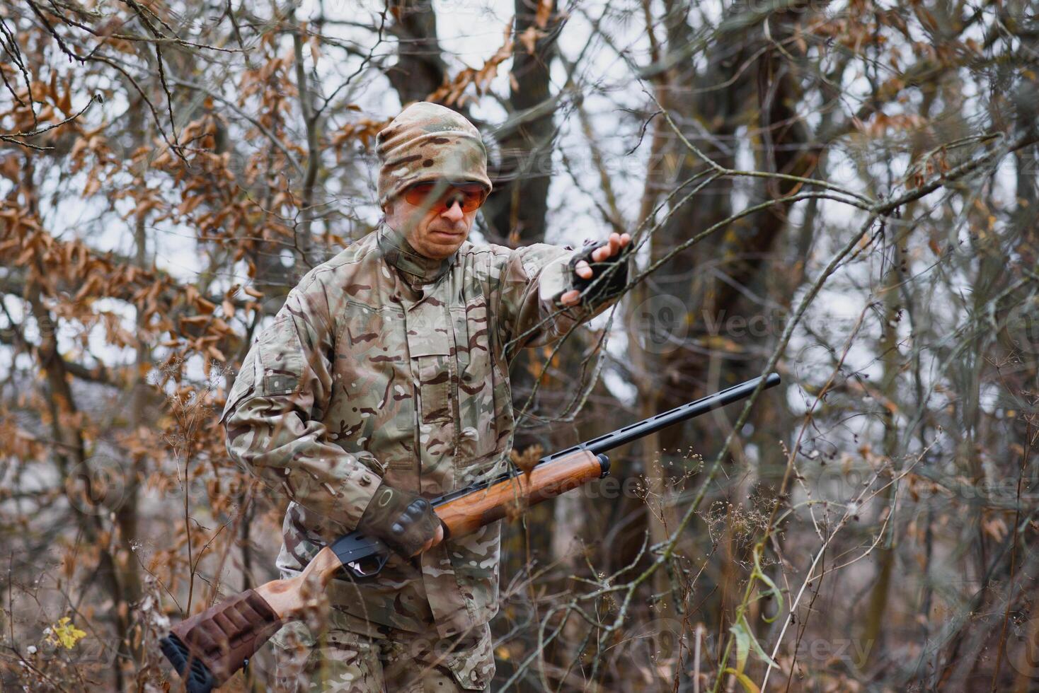 Hunter in uniform with a hunting rifle. Hunting Concept. photo