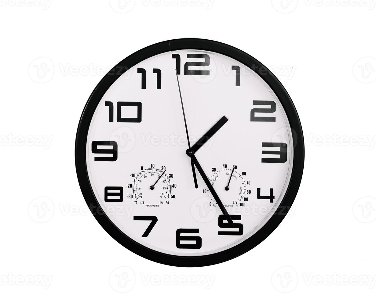 simple classic black and white round wall clock isolated on white. Clock with arabic numerals on wall shows photo