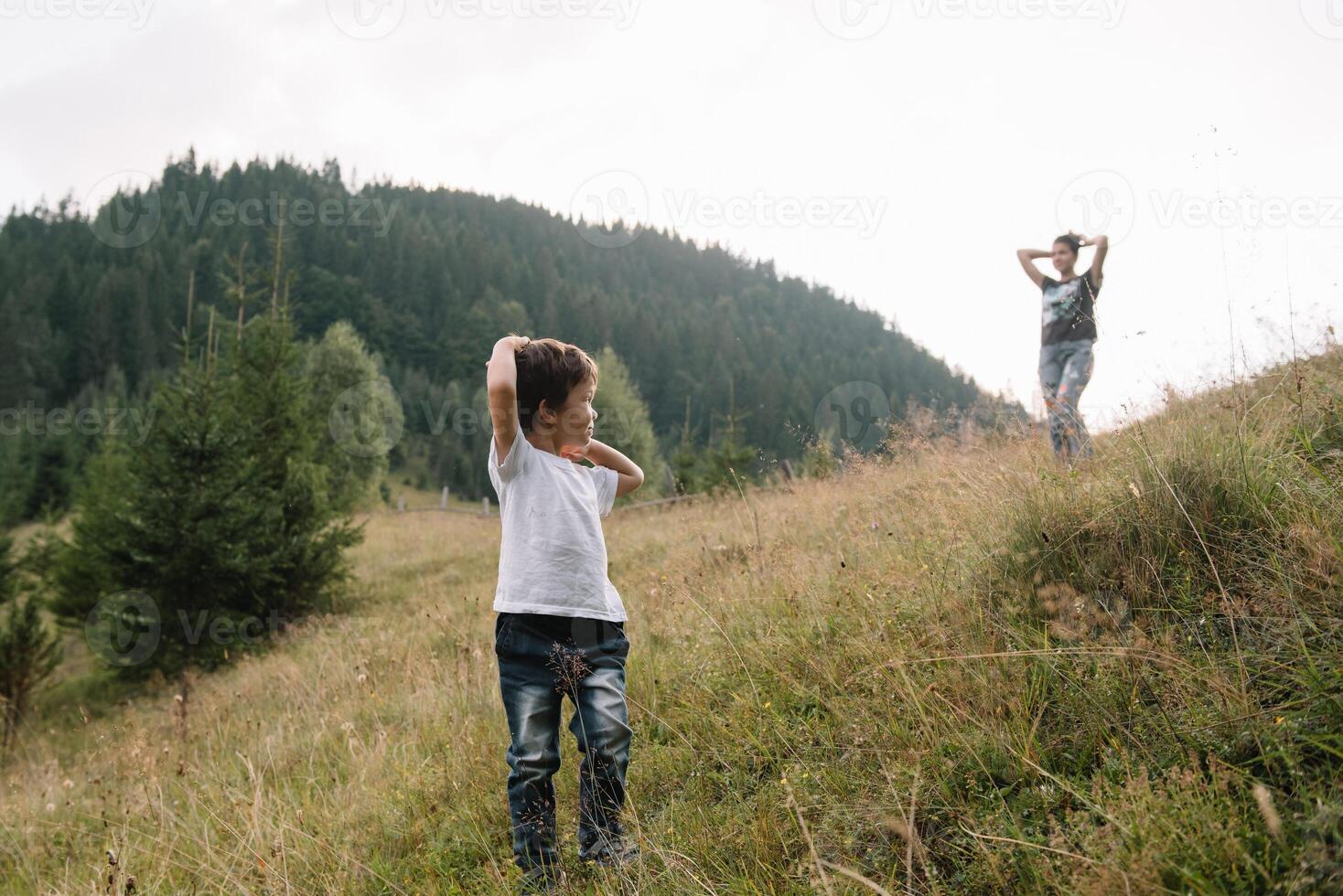 Young mom with baby boy travelling. Mother on hiking adventure with child, family trip in mountains. National Park. Hike with children. Active summer holidays. Fisheye lens. photo