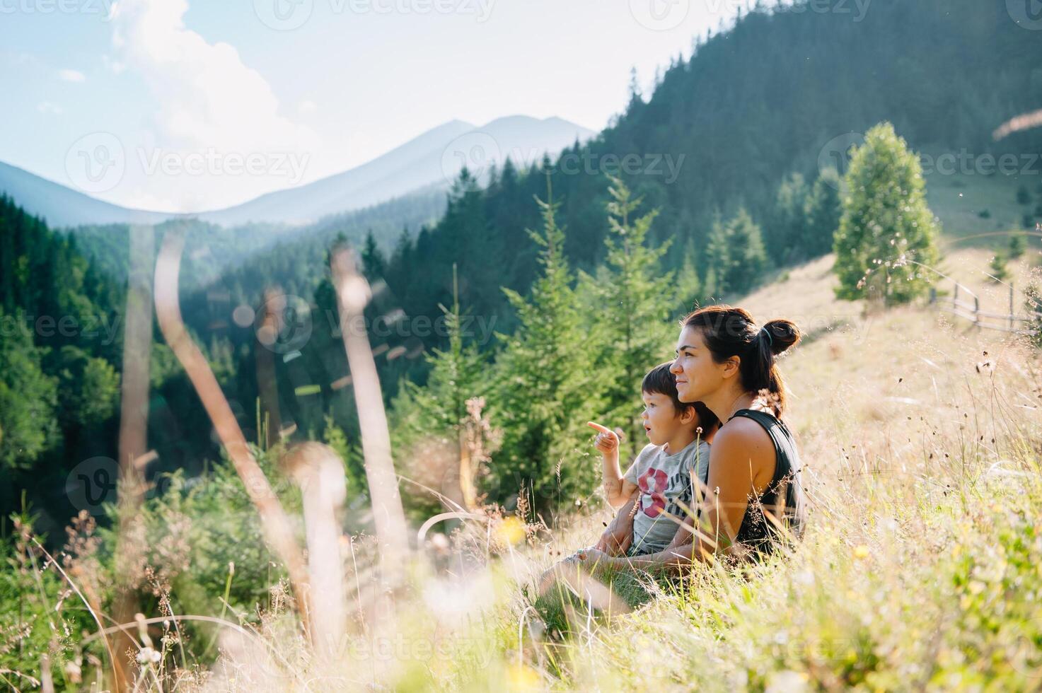 Young mom with baby boy travelling. Mother on hiking adventure with child, family trip in mountains. National Park. Hike with children. Active summer holidays. Fisheye lens. photo