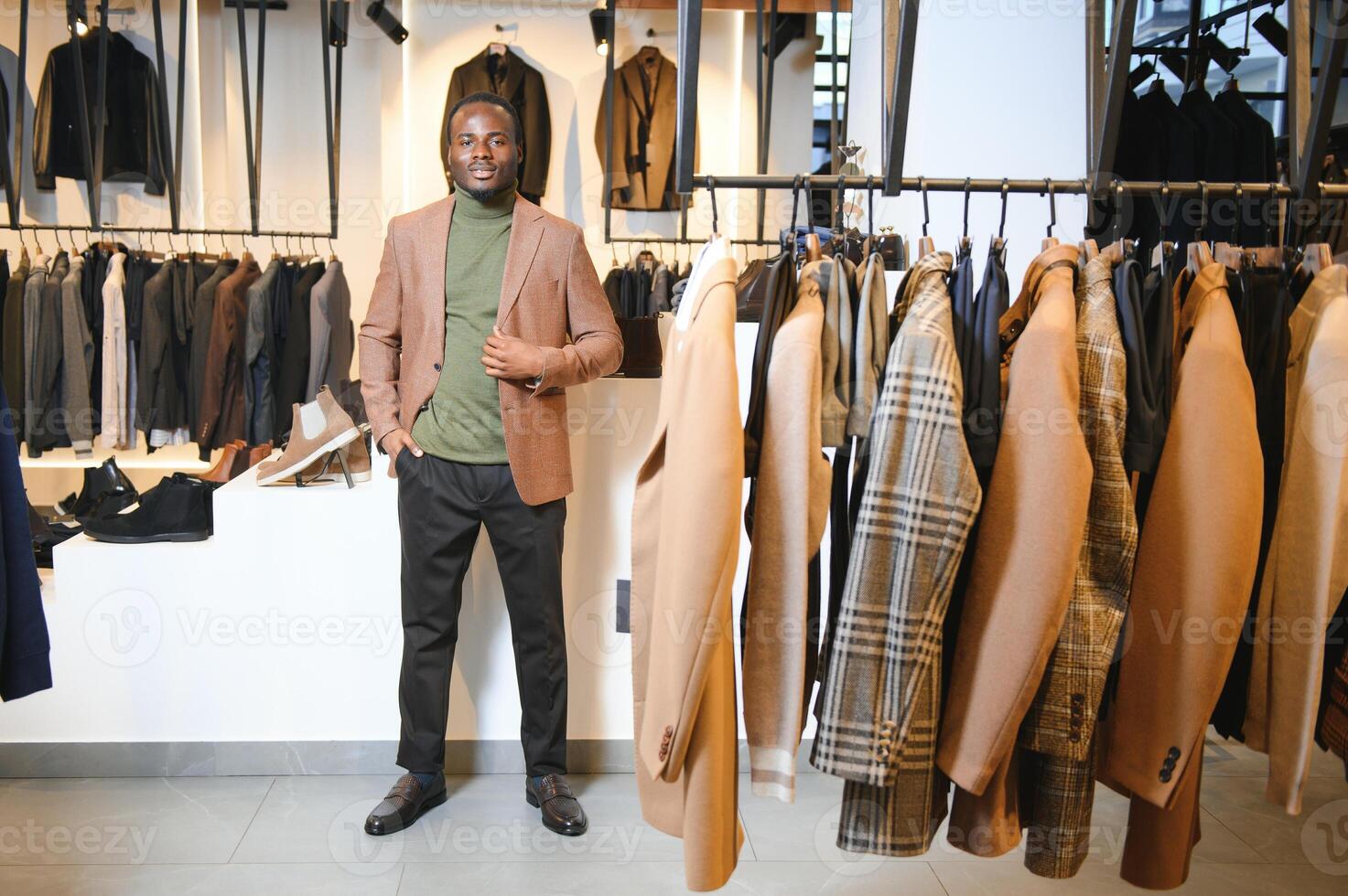 A handsome young african gentleman buying an elegant suit photo