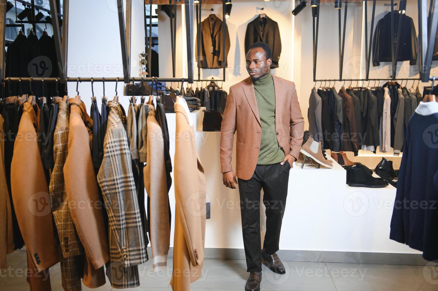 A handsome young african gentleman buying an elegant suit photo