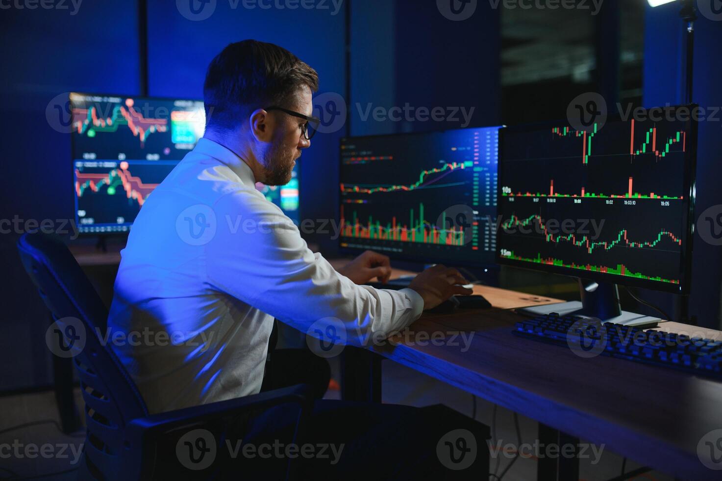 Financial Analyst. Businessman Works in Investment Bank Downtown Office at Night photo