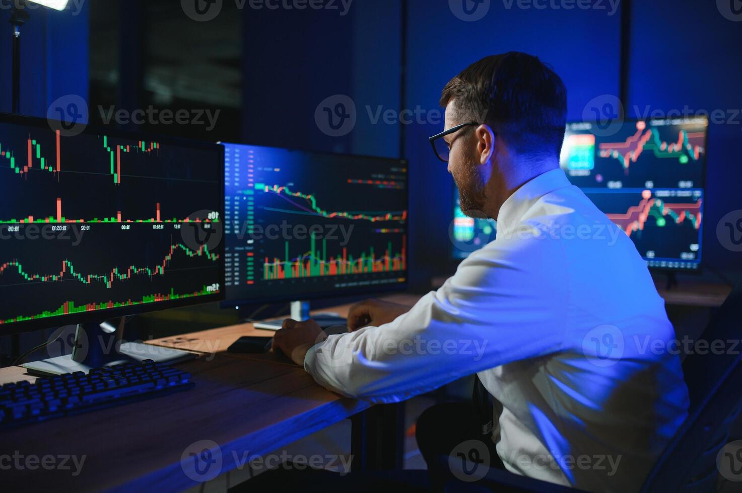 Financial Analyst. Businessman Works in Investment Bank Downtown Office at Night photo