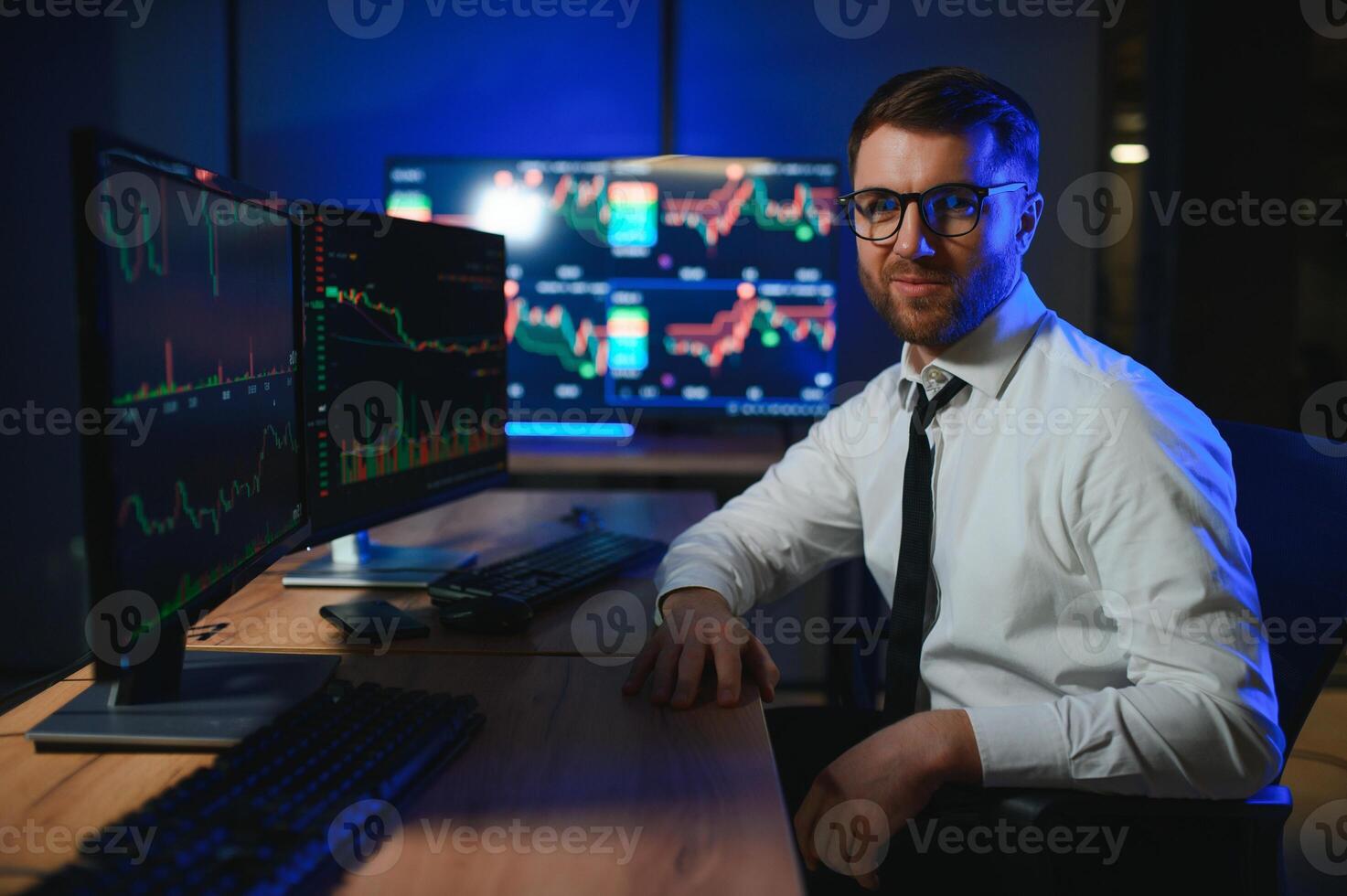 Financial Analyst. Businessman Works in Investment Bank Downtown Office at Night photo