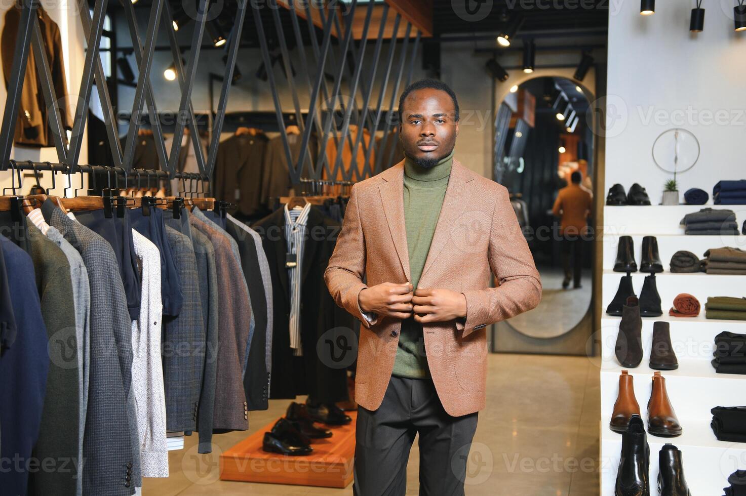 A handsome young african gentleman buying an elegant suit photo