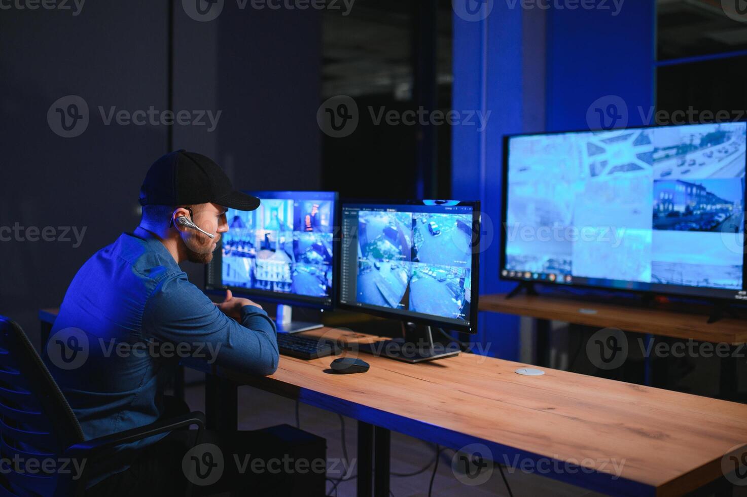 Male security guard in surveillance room photo