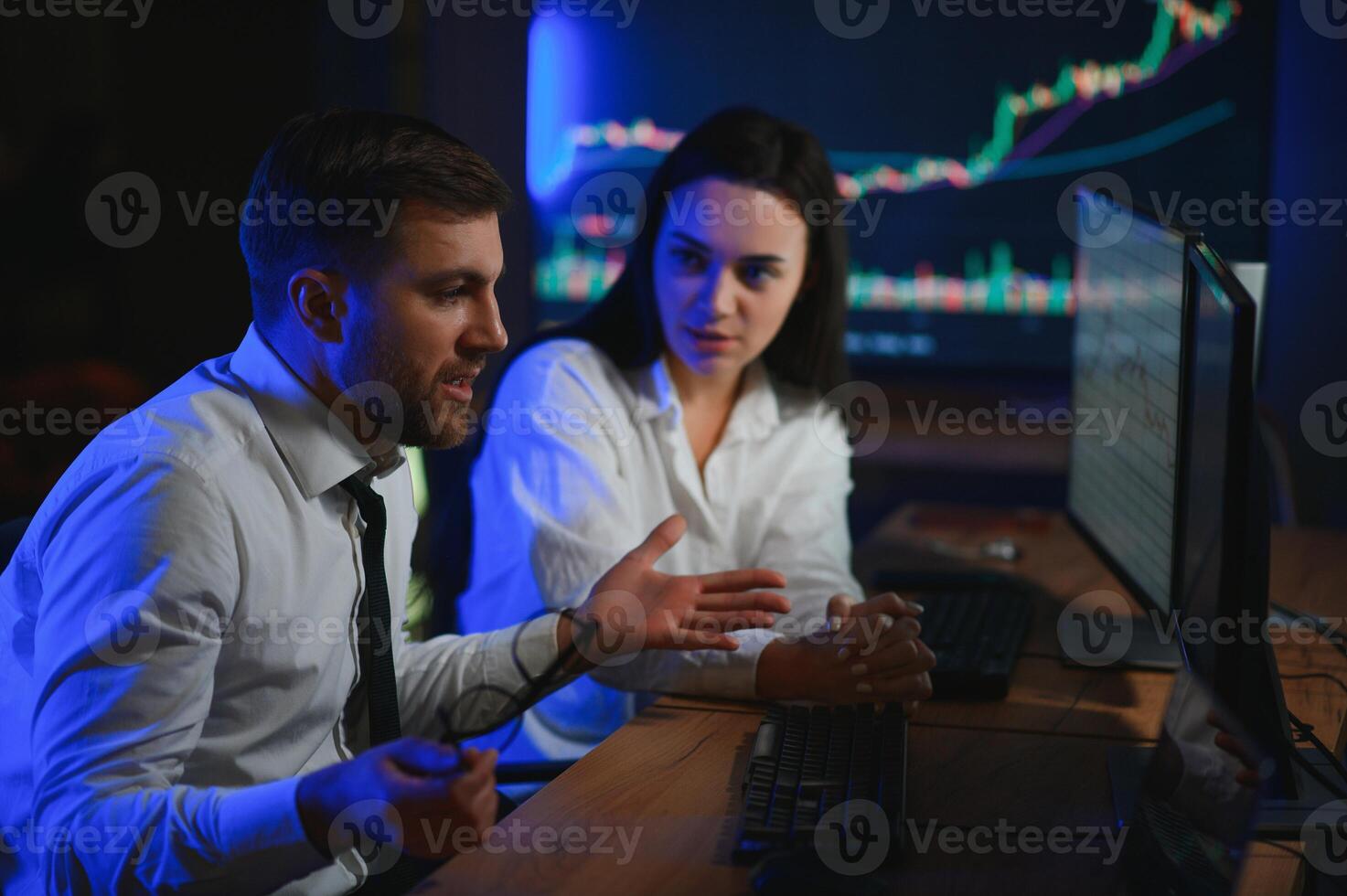 Financial Analyst Talking to Investment Banker in Late Evening at Work photo
