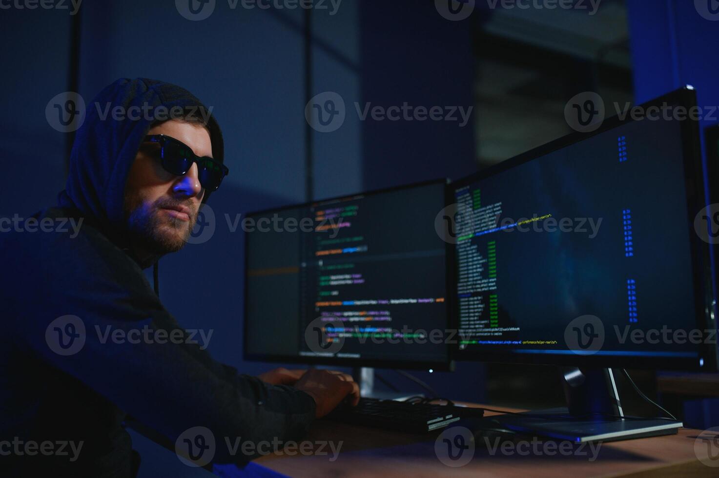 Hacker is hacking into the computer network. Computer criminal photo