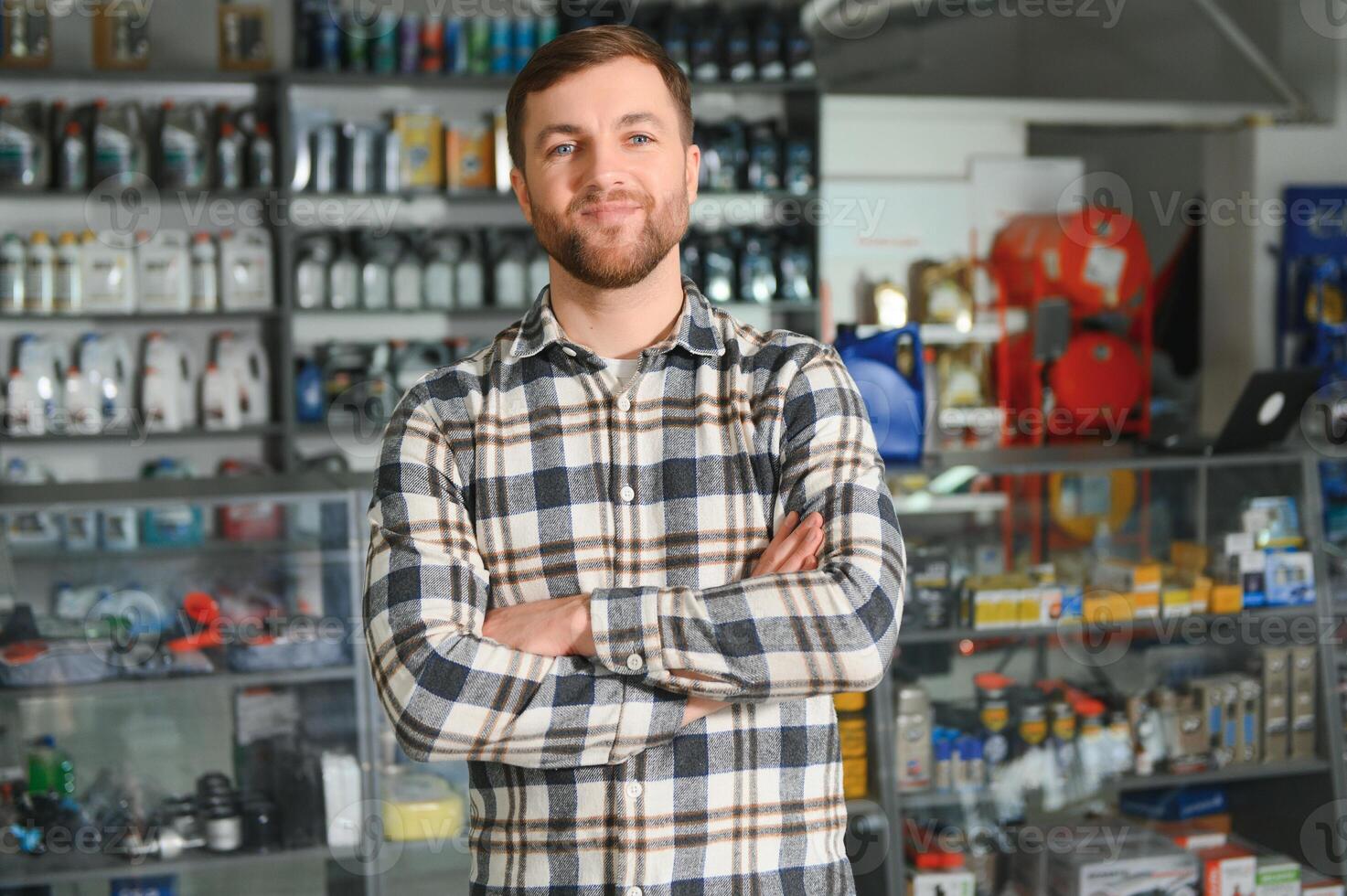 A salesman in an auto parts store. Retail trade of auto parts photo