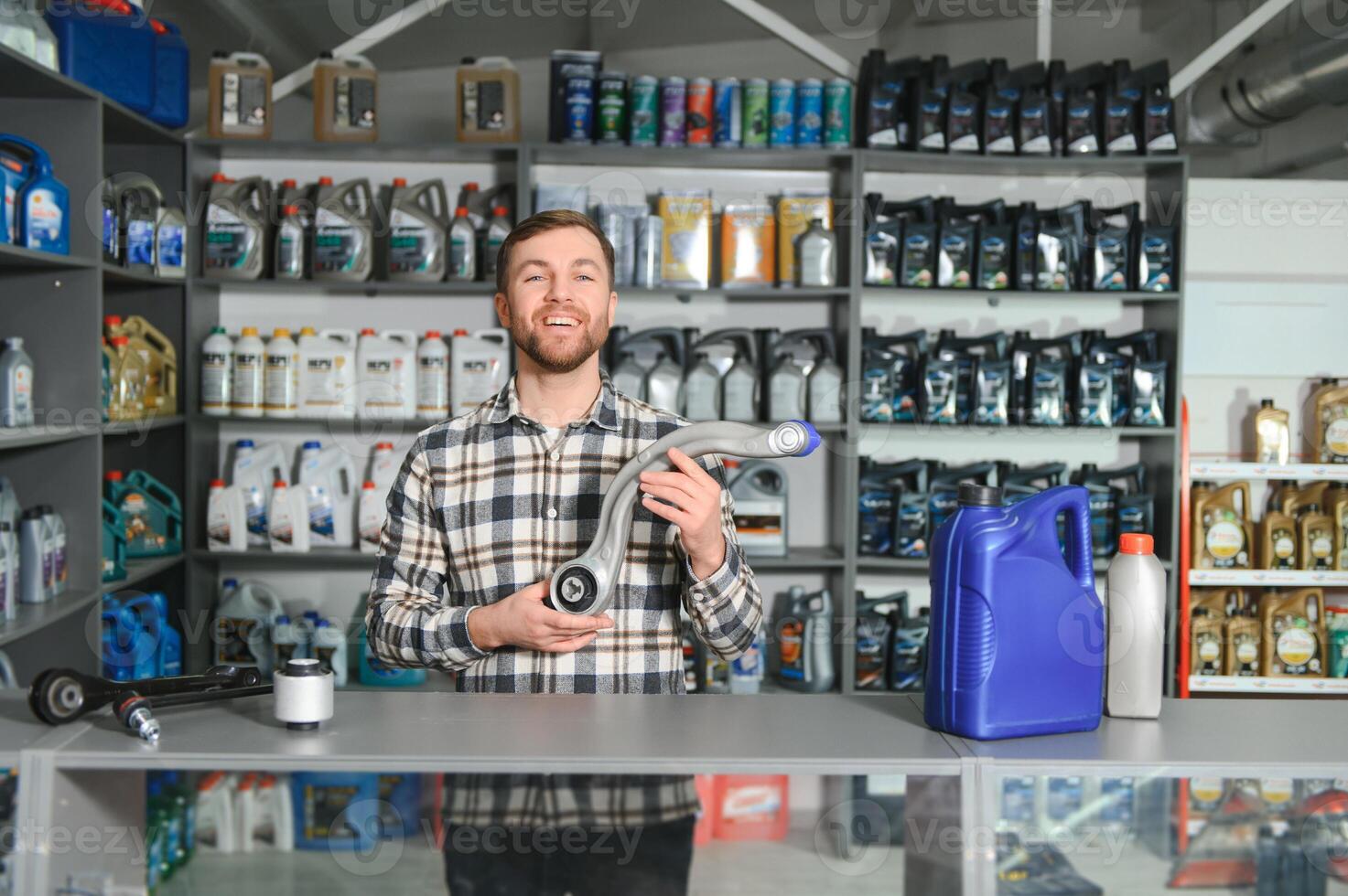 Portrait of a handsome salesman in an auto parts store. The concept of car repair photo