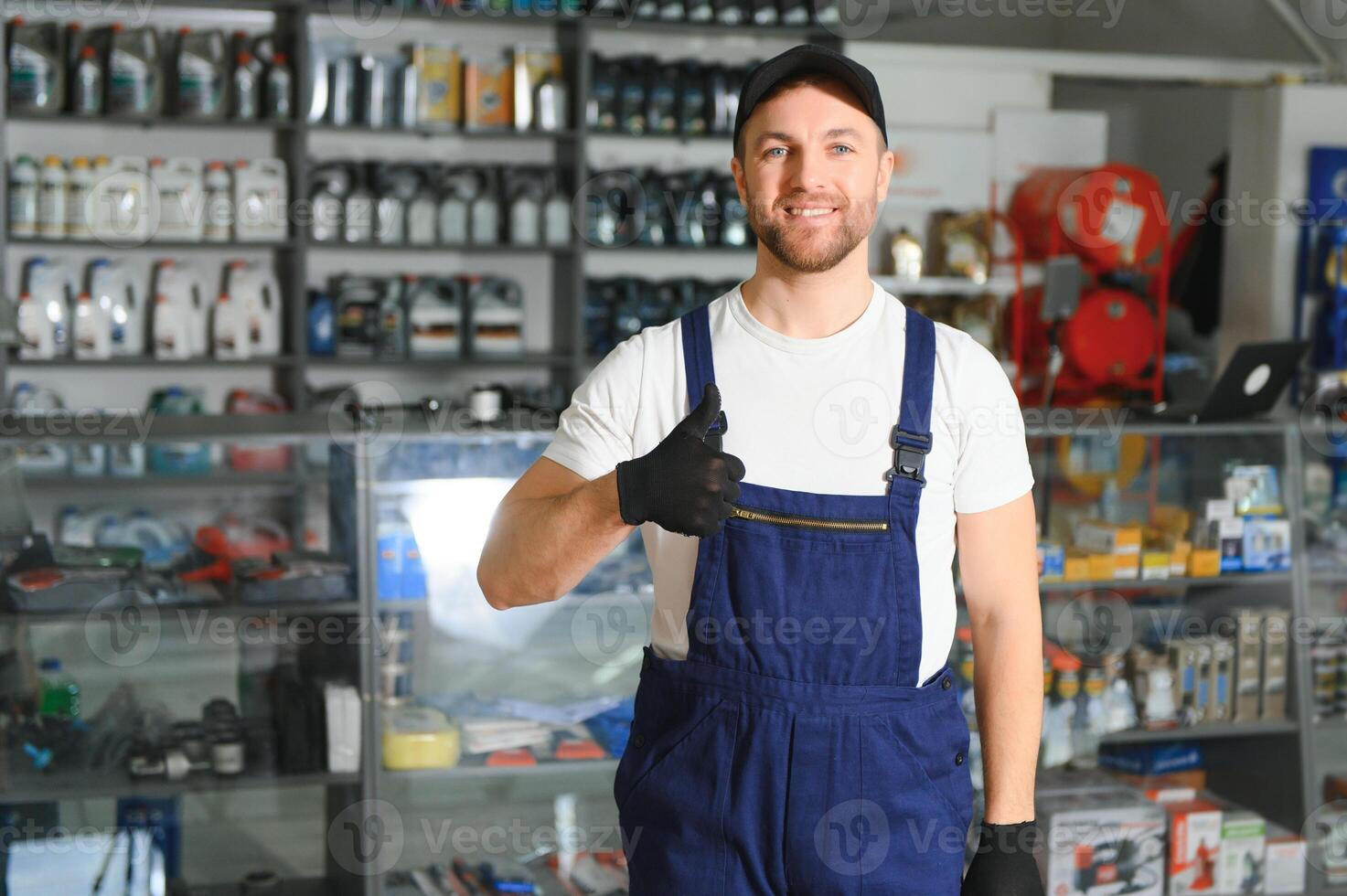 A salesman in an auto parts store. Retail trade of auto parts photo