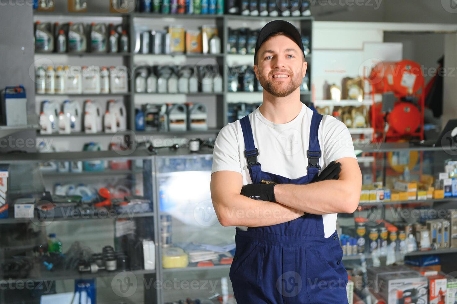 A salesman in an auto parts store. Retail trade of auto parts photo