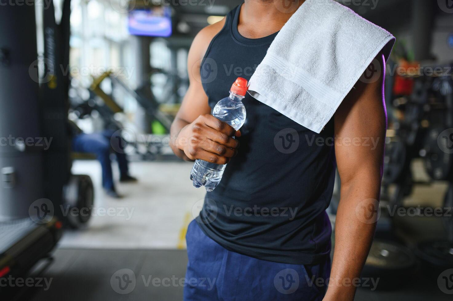 happy young african man drinking water after exercise photo