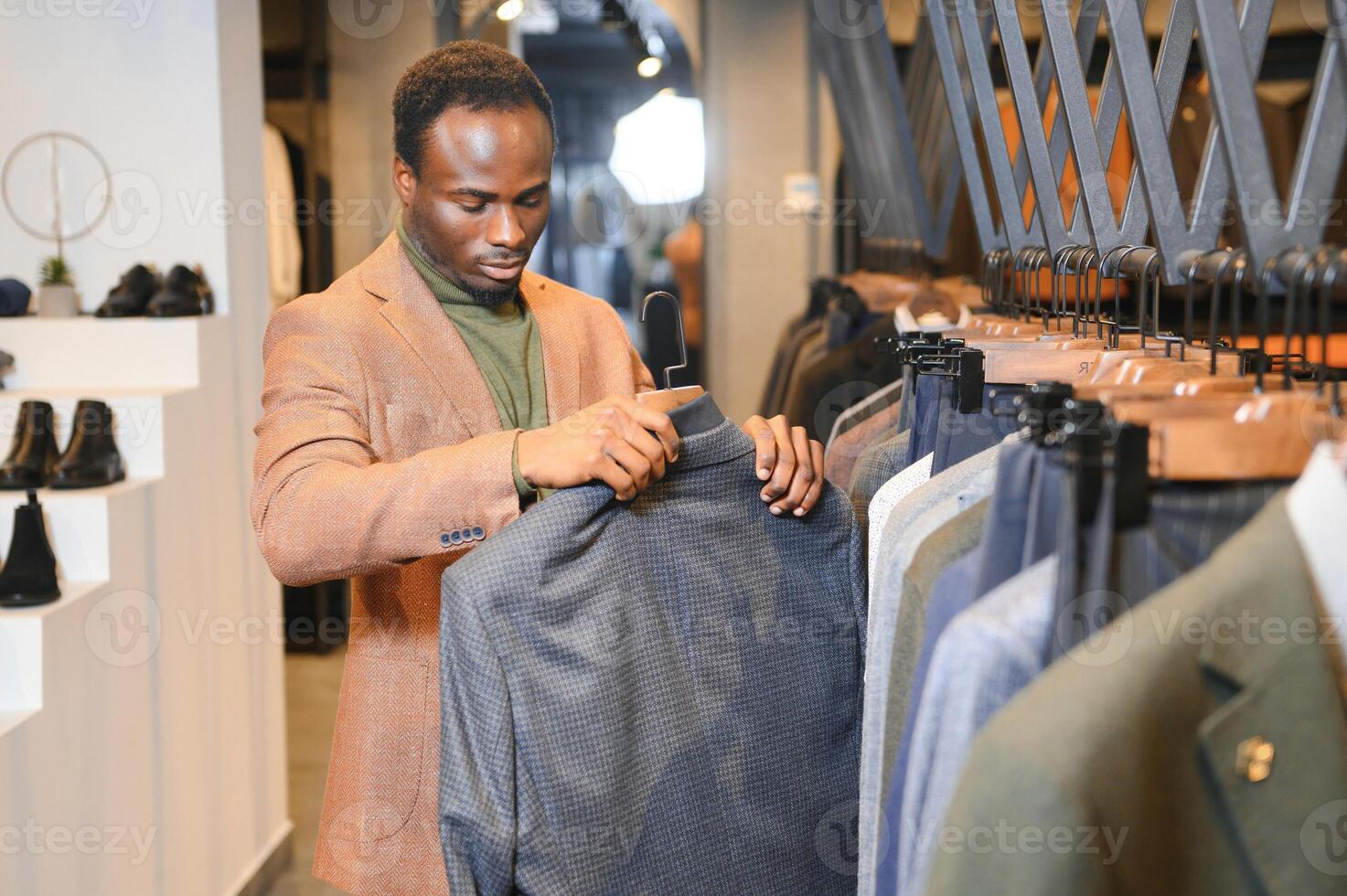 A handsome young african gentleman buying an elegant suit photo