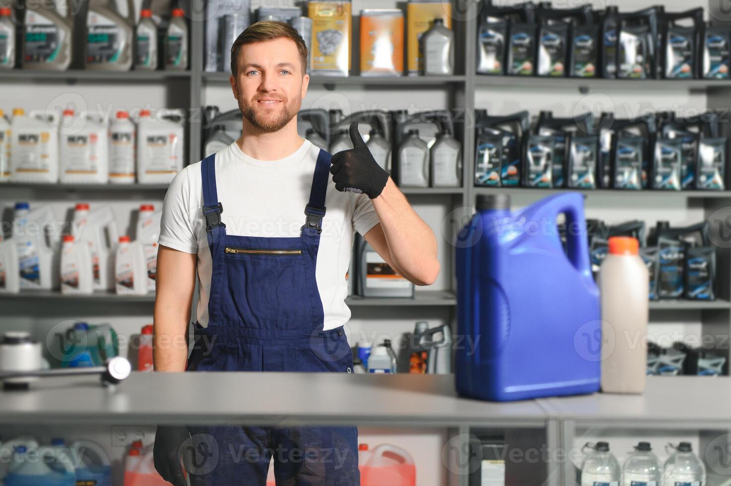 A salesman in an auto parts store. Retail trade of auto parts photo