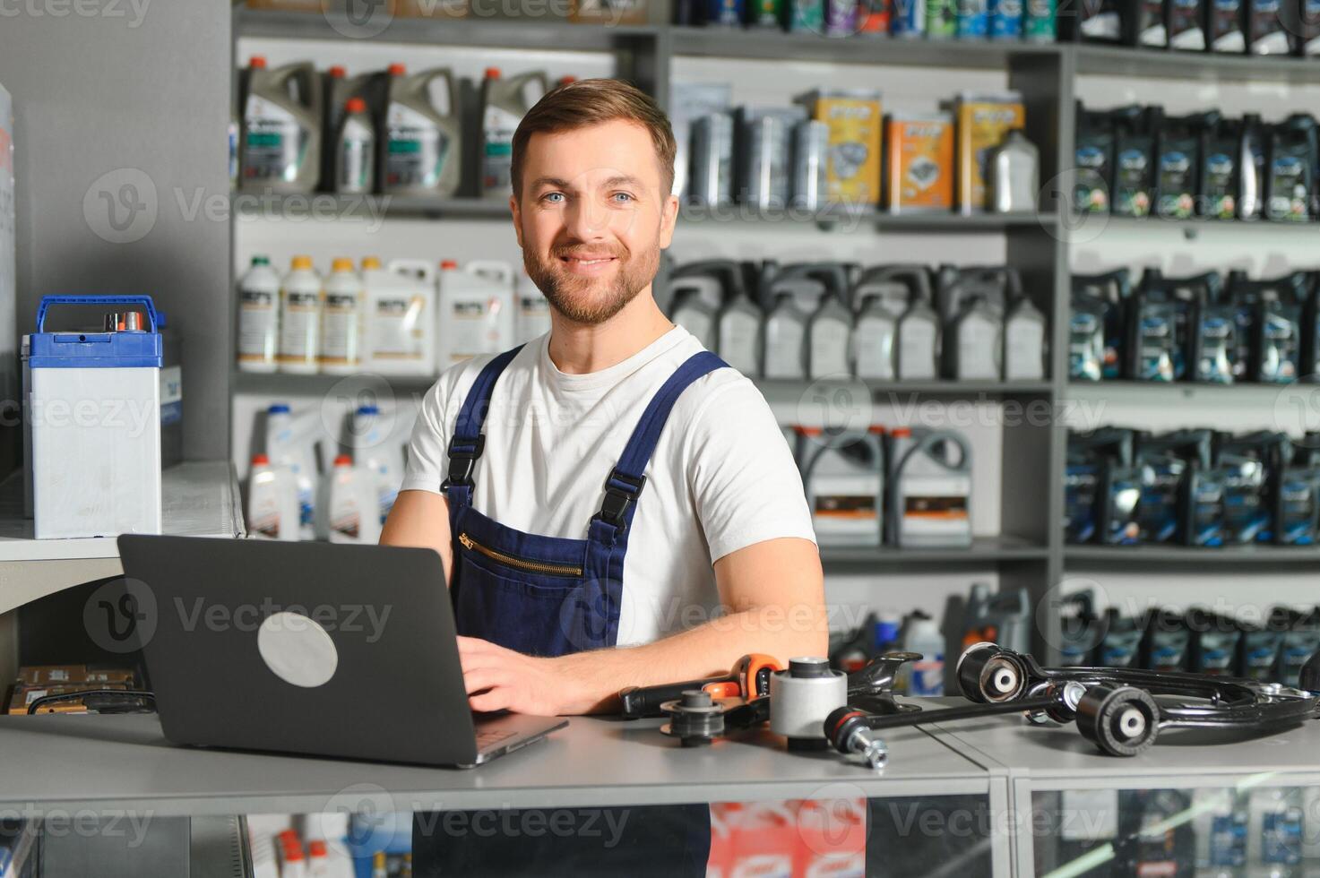 Portrait of a handsome salesman in an auto parts store. The concept of car repair photo