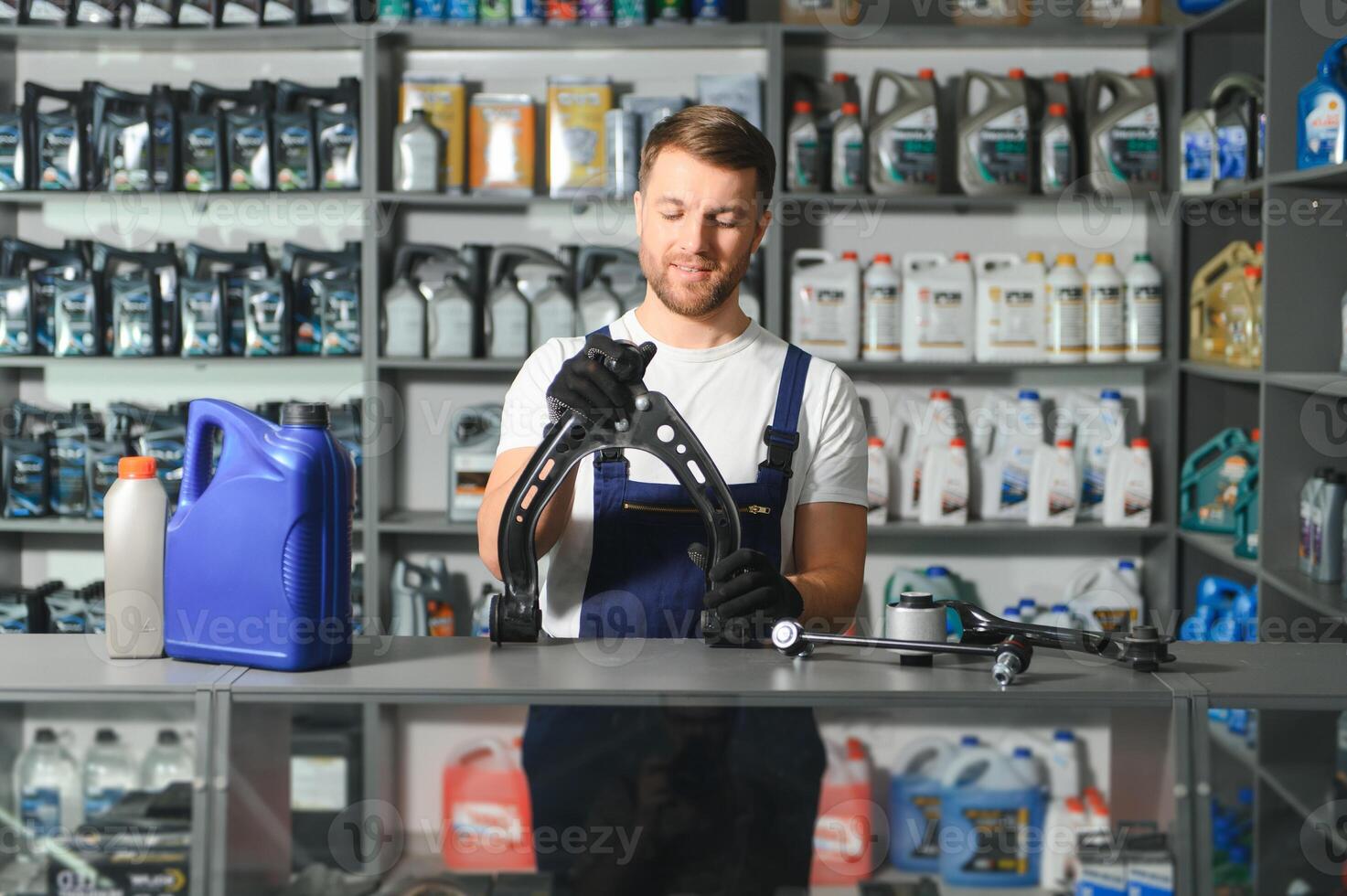 A salesman in an auto parts store. Retail trade of auto parts photo