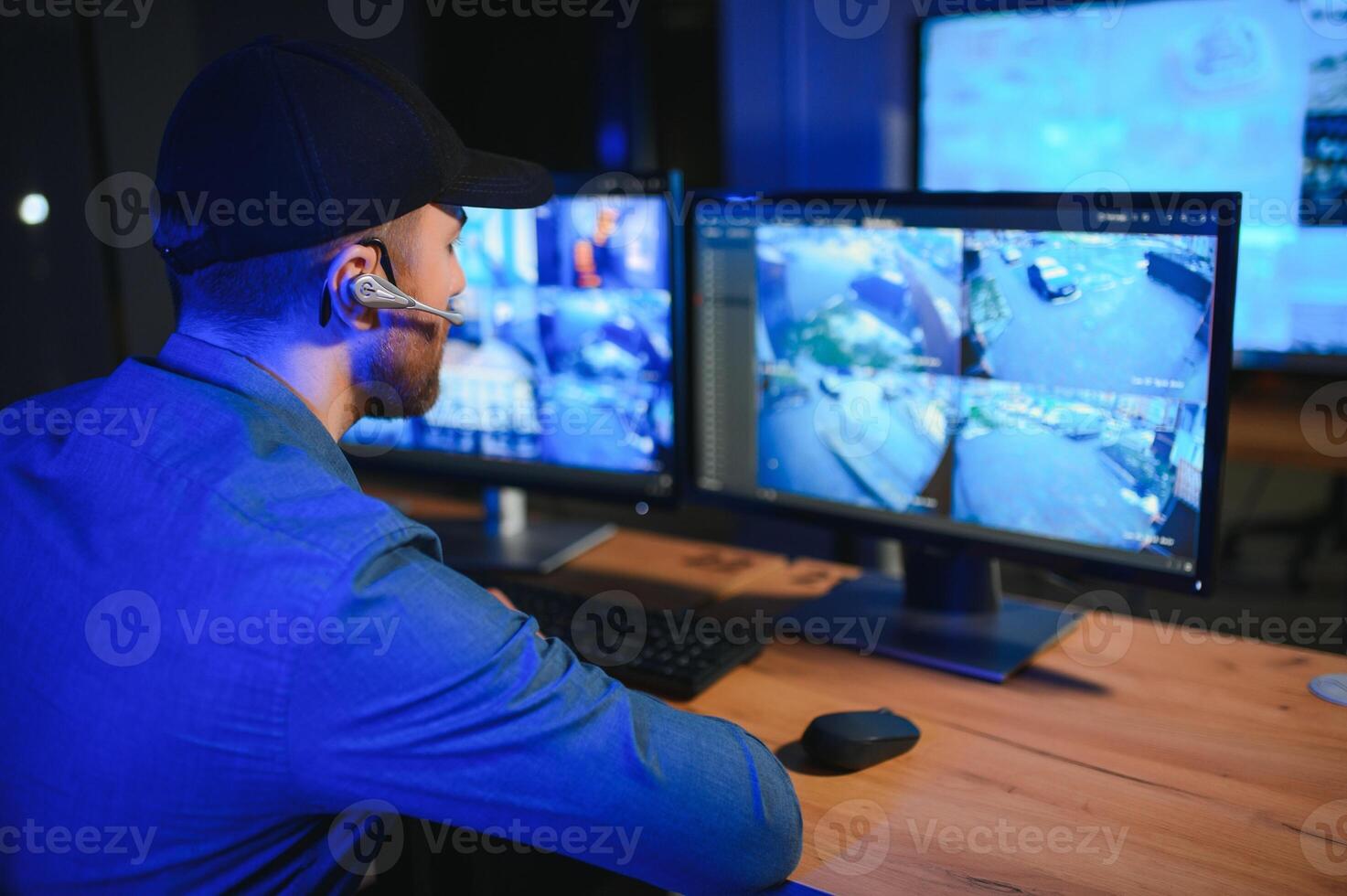 Male security guard in surveillance room photo