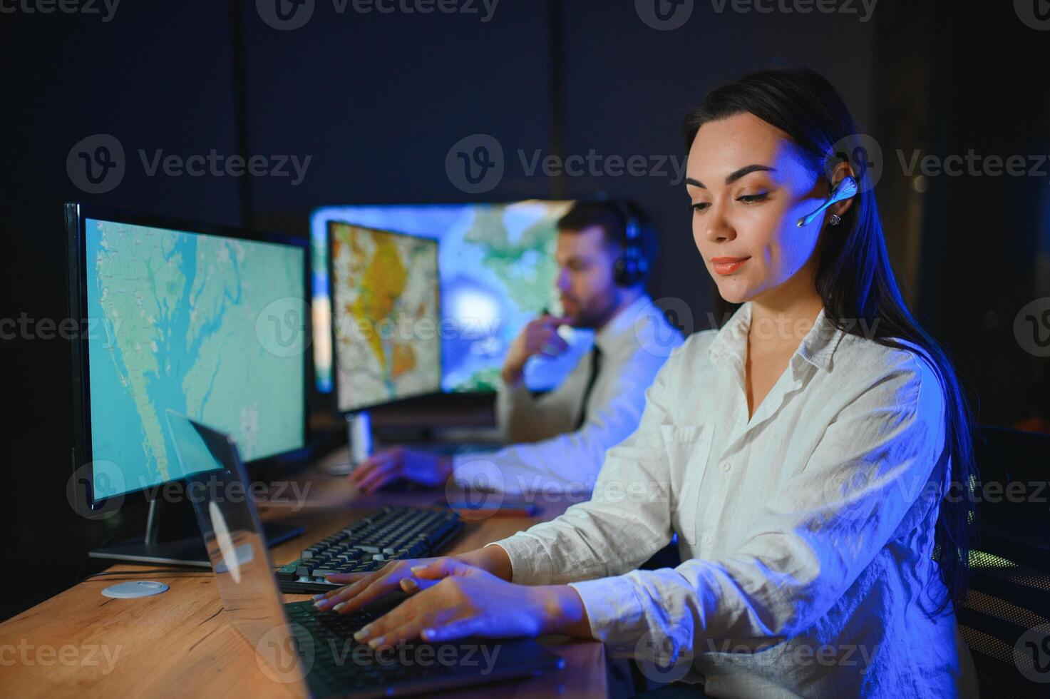 Smiling friendly female call center agent with headset working on support hotline in the office photo