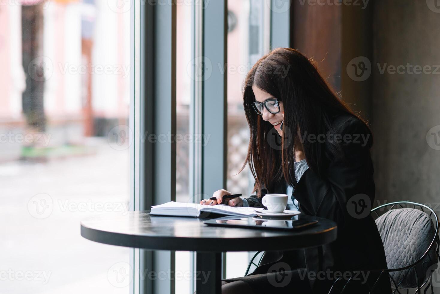 Young businesswoman talking on the phone in coffee shop. photo