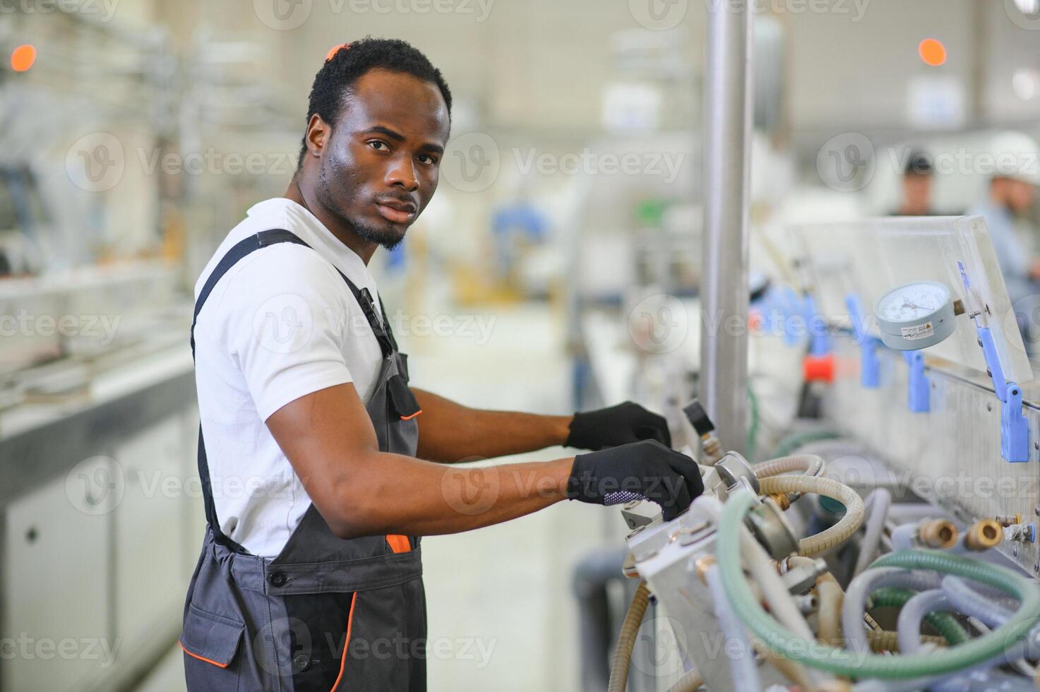 Factory for aluminum and PVC windows and doors production. Manual worker assembling PVC windows and doors photo