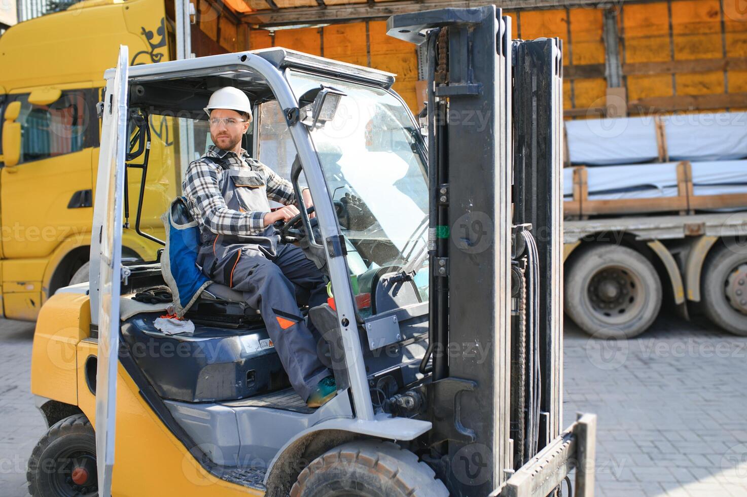 Man worker at forklift driver happy working in industry factory logistic ship photo