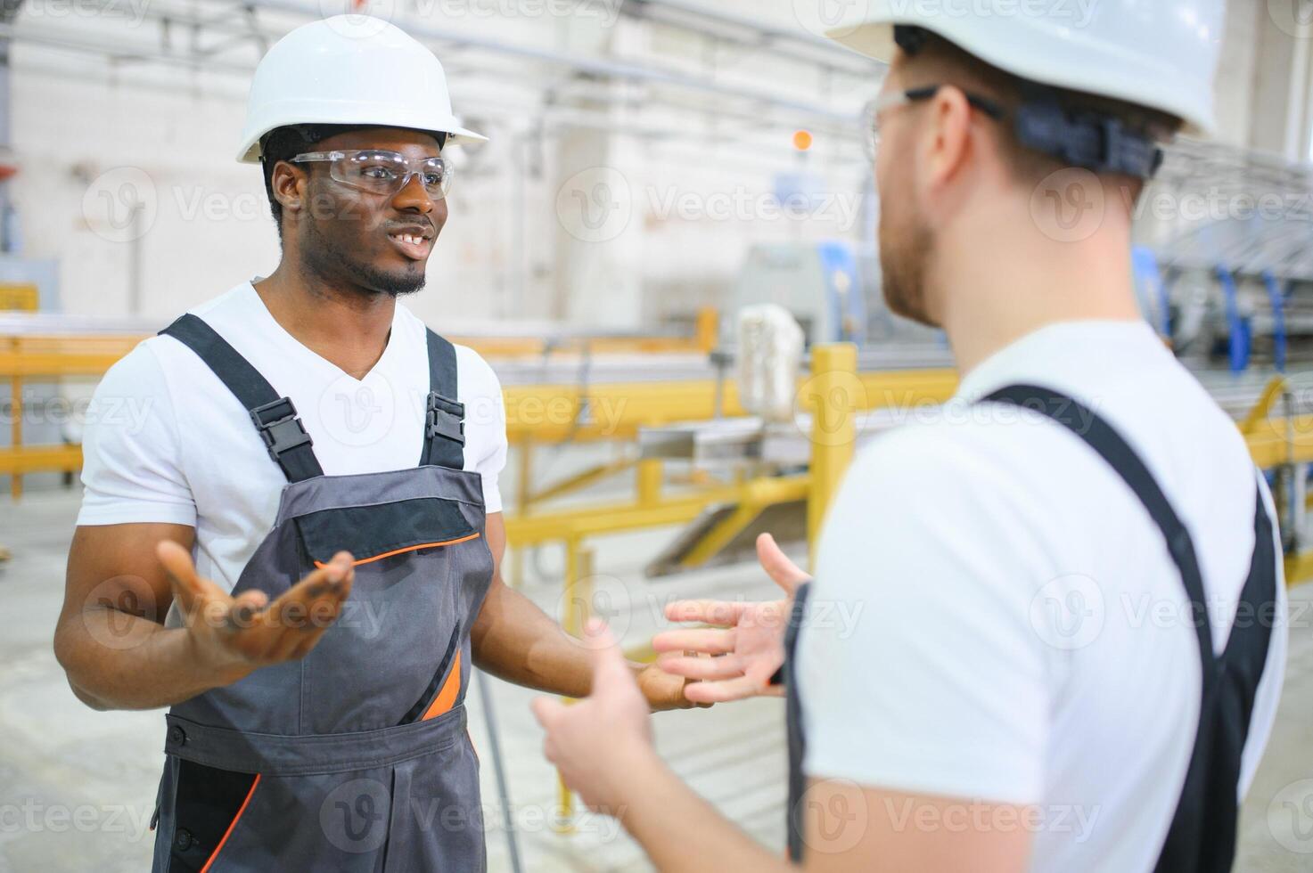 Two workers at the factory. Engineer and worker photo