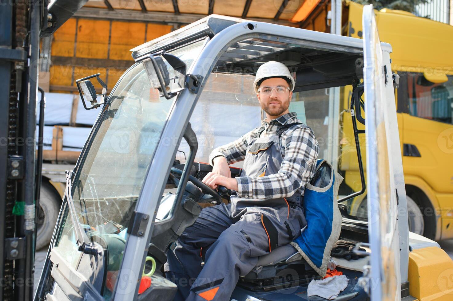 A man on a forklift works in a large warehouse, unloads bags of raw materials photo